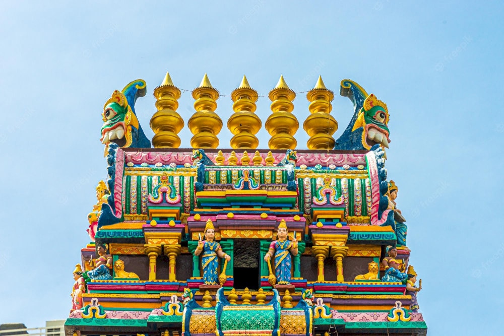 Detailed carvings on the Gopuram showing Hindu gods and mythological creatures in South Indian style